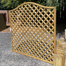 Wooden lattice panel on a gravel surface with trees in the background
