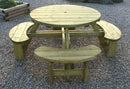 A round garden picnic table made of softwood with four attached moon shaped benches, displayed on a gravel surface.