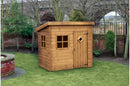 A wooden Mini Pent House shed with a door, two windows, and a roof canopy situated on grass with a garden and brick wall in the background.